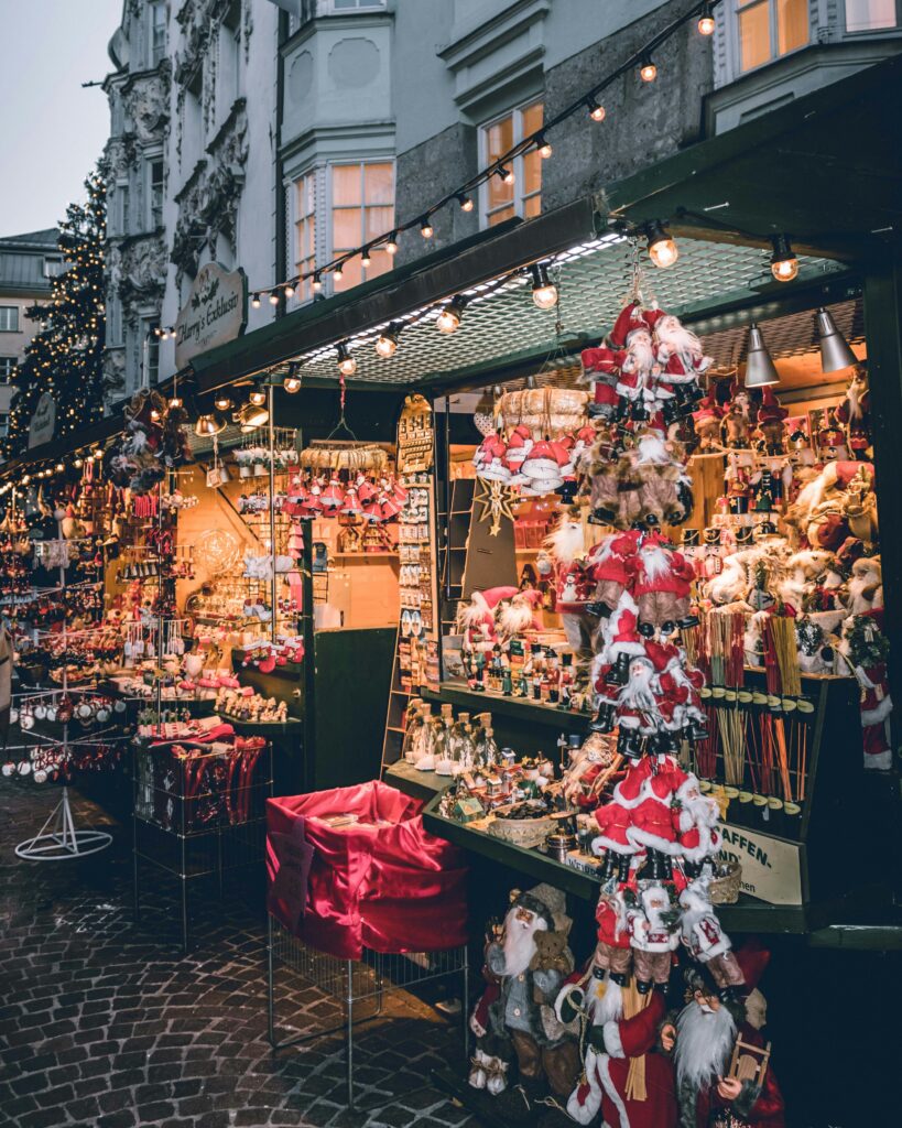 European Christmas market with wooden stalls and festive lights.