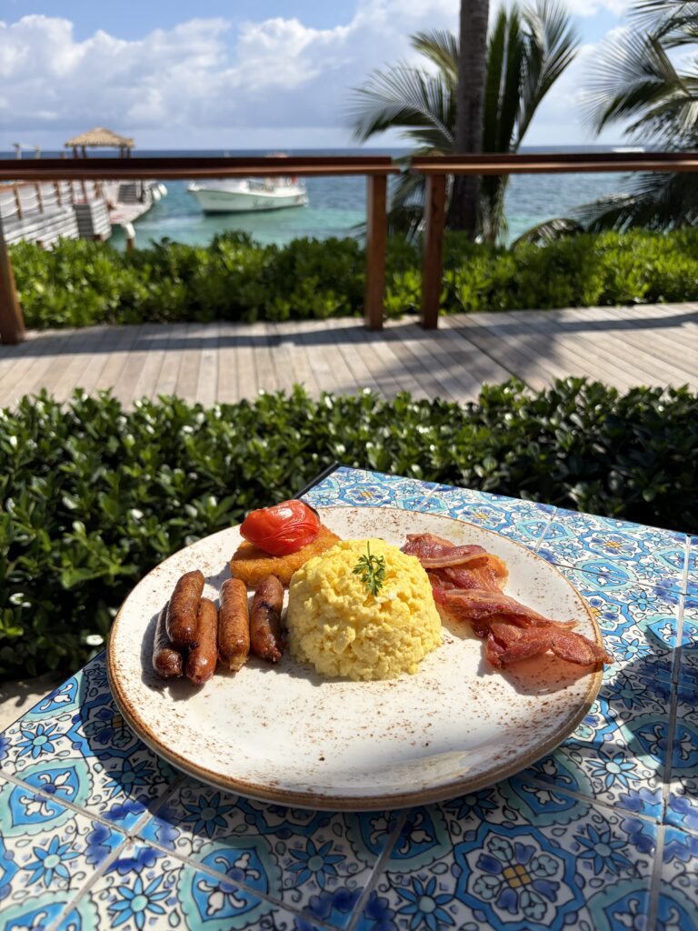 American breakfast overlooking the water and dock at Sandals Dunn’s River in Jamaica, featuring a tropical oceanfront morning view.