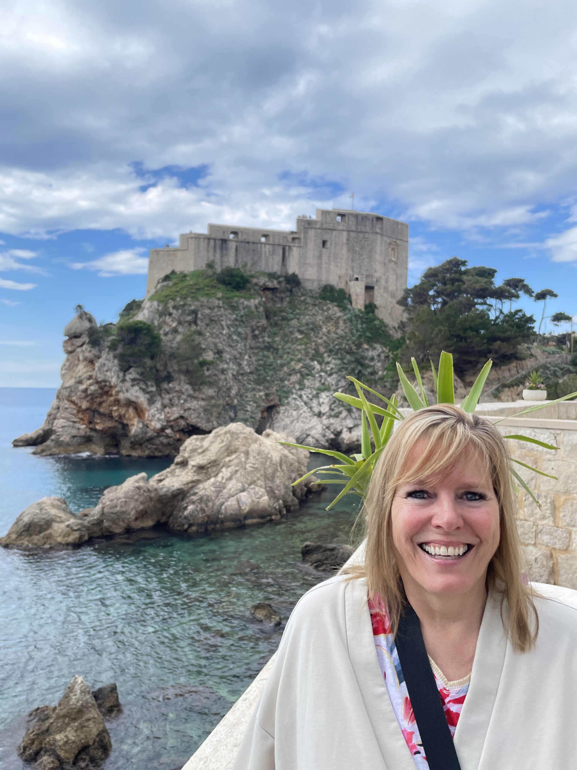 Standing in front of a historic building in Croatia while exploring the country.