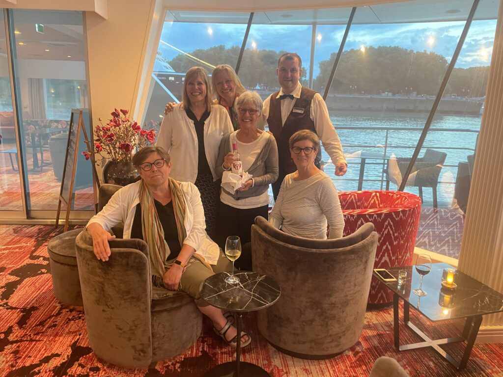 A group of solo travelers gathering in the lounge aboard an AmaWaterways river cruise ship.