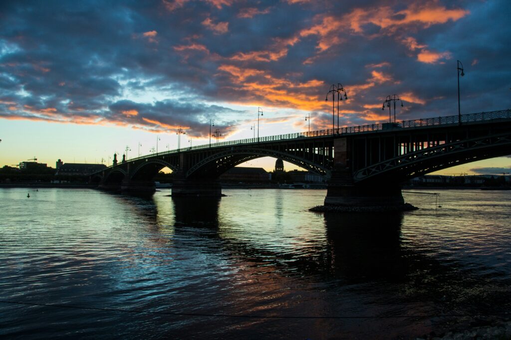 European river cruise water levels beneath a bridge at sunset