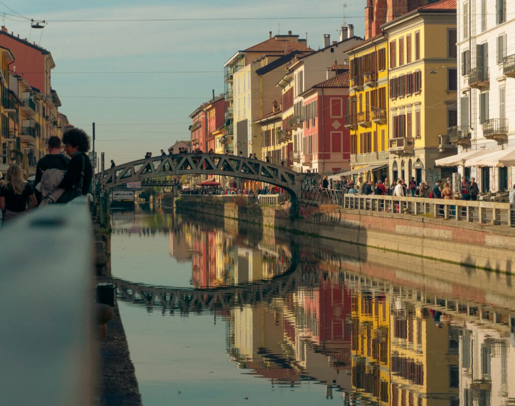 Colorful buildings and canal reflected in the water in Milan’s Navigli district